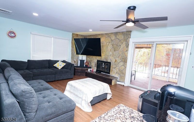 Fireplace, Interior, Living room, Recessed Lighting, Stone Walls, Wood Texture Flooring