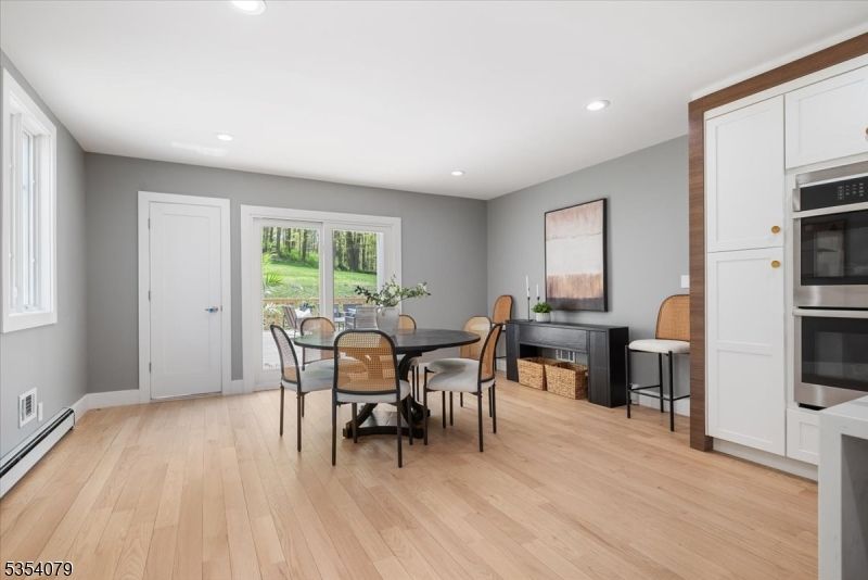 Dining room, Fireplace, Interior, Kitchen, Recessed Lighting, Stainless Steel Appliances, Wood Texture Flooring