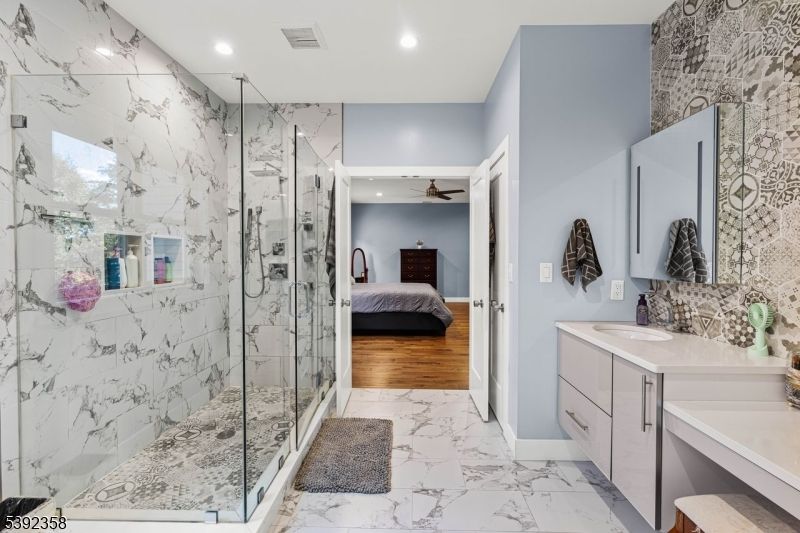Bathroom, Bedroom, Dual Sink Vanities, Glass Shower, Interior, Marble, Marble Walls, Recessed Lighting, Wood Texture Flooring