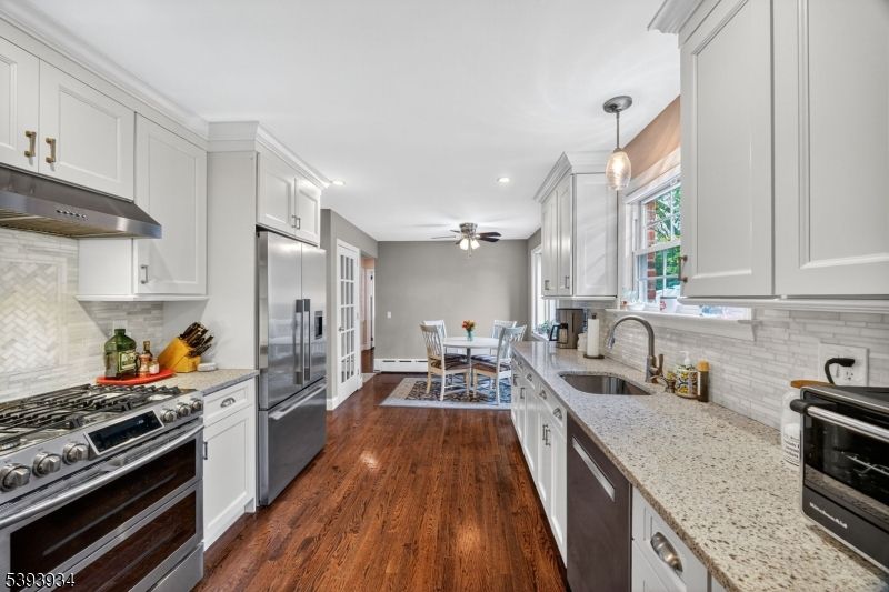 Dining room, Interior, Kitchen, Pendant Lights, Recessed Lighting, Stainless Steel Appliances, Wood Texture Flooring