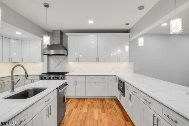 Interior, Kitchen, Marble Walls, Pendant Lights, Recessed Lighting, Stainless Steel Appliances, Wood Texture Flooring
