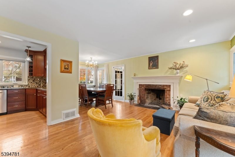 Chandelier, Dining room, Fireplace, Interior, Living room, Recessed Lighting, Wood Texture Flooring