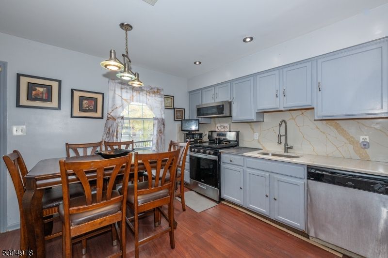 Dining room, Interior, Kitchen, Pendant Lights, Recessed Lighting, Stainless Steel Appliances, Wood Texture Flooring