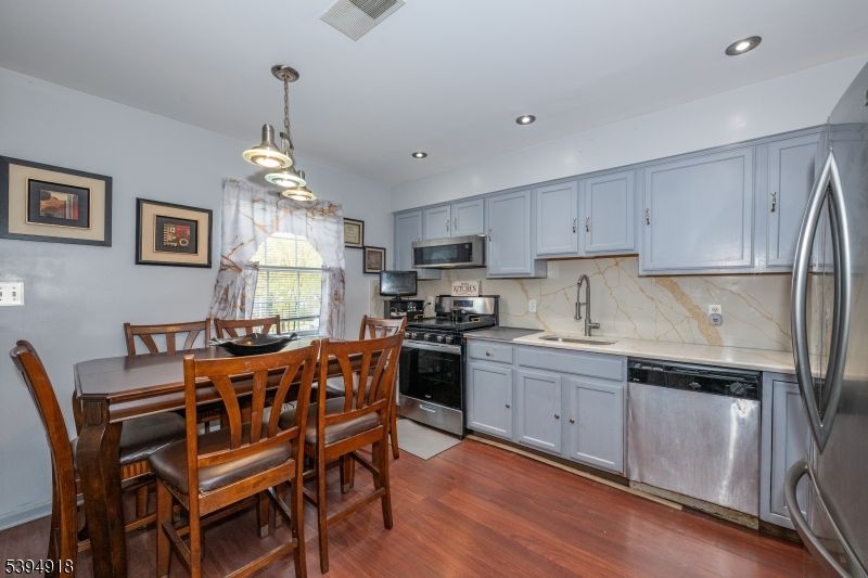 Dining room, Interior, Kitchen, Marble Walls, Pendant Lights, Recessed Lighting, Stainless Steel Appliances, Wood Texture Flooring