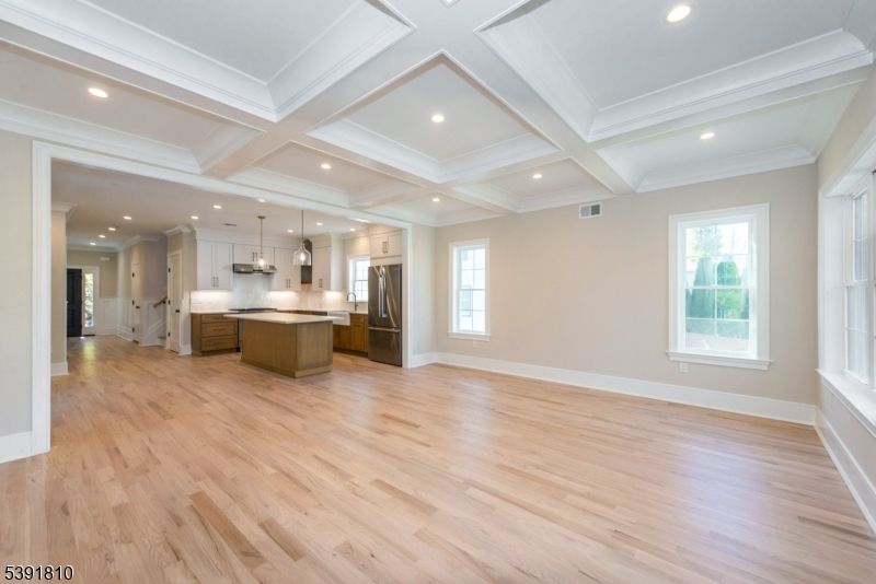 Empty room, Interior, Kitchen, Pendant Lights, Recessed Lighting, Stainless Steel Appliances, Wood Texture Flooring