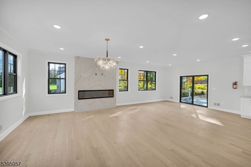 Chandelier, Empty room, Fireplace, Interior, Marble Walls, Pendant Lights, Recessed Lighting, Wood Texture Flooring