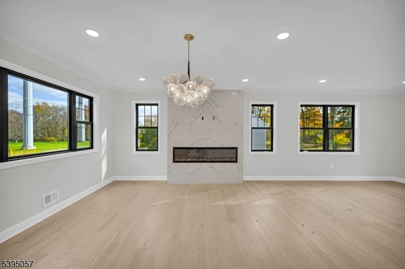 Chandelier, Empty room, Fireplace, Interior, Marble Walls, Pendant Lights, Recessed Lighting, Wood Texture Flooring