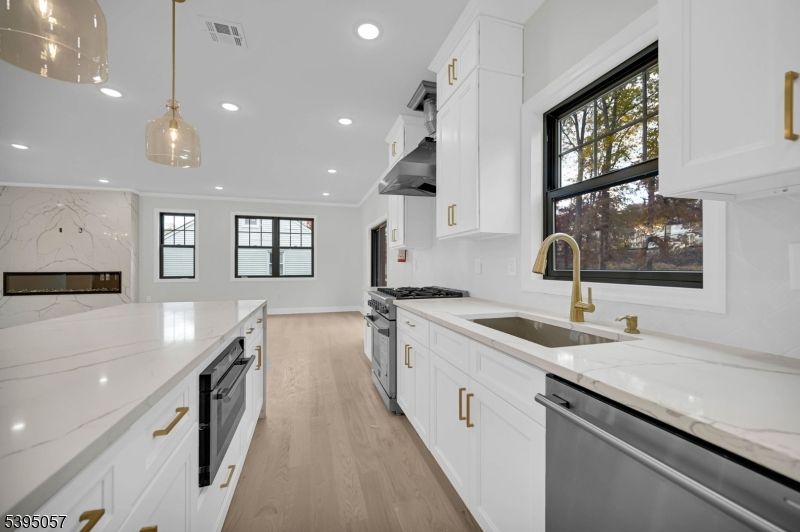 Interior, Kitchen, Marble Walls, Pendant Lights, Recessed Lighting, Stainless Steel Appliances, Wood Texture Flooring