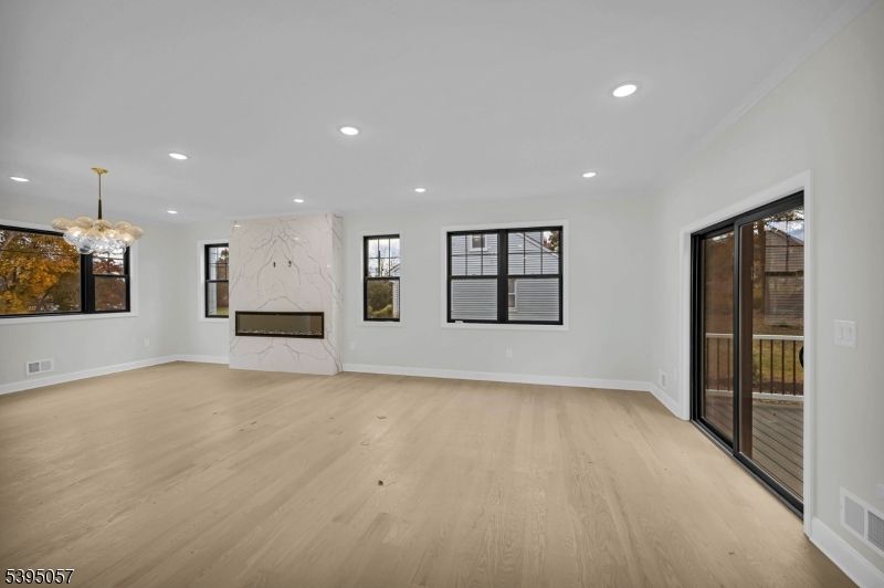 Chandelier, Empty room, Fireplace, Interior, Marble Walls, Recessed Lighting, Wood Texture Flooring