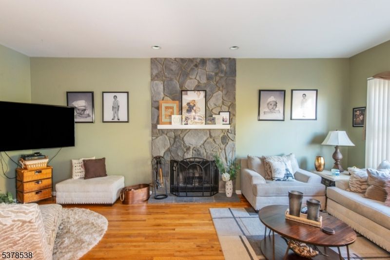 Fireplace, Interior, Living room, Recessed Lighting, Stone Walls, Wood Texture Flooring