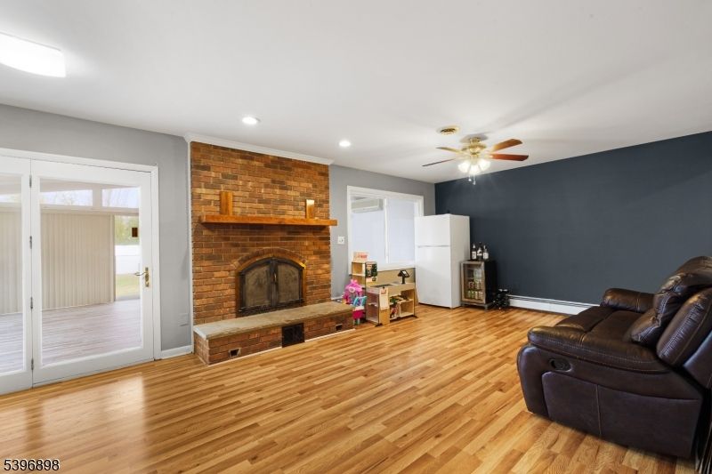 Fireplace, Interior, Living room, Recessed Lighting, Stone Walls, Wood Texture Flooring