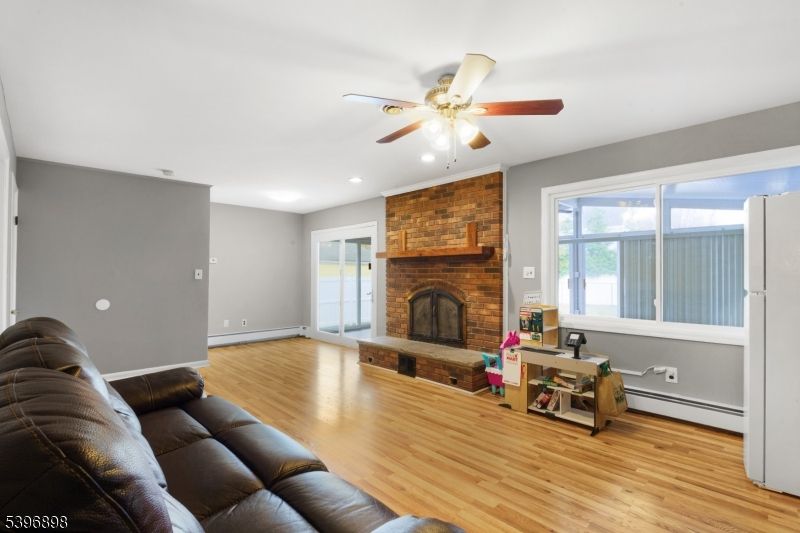 Fireplace, Interior, Living room, Recessed Lighting, Stone Walls, Wood Texture Flooring