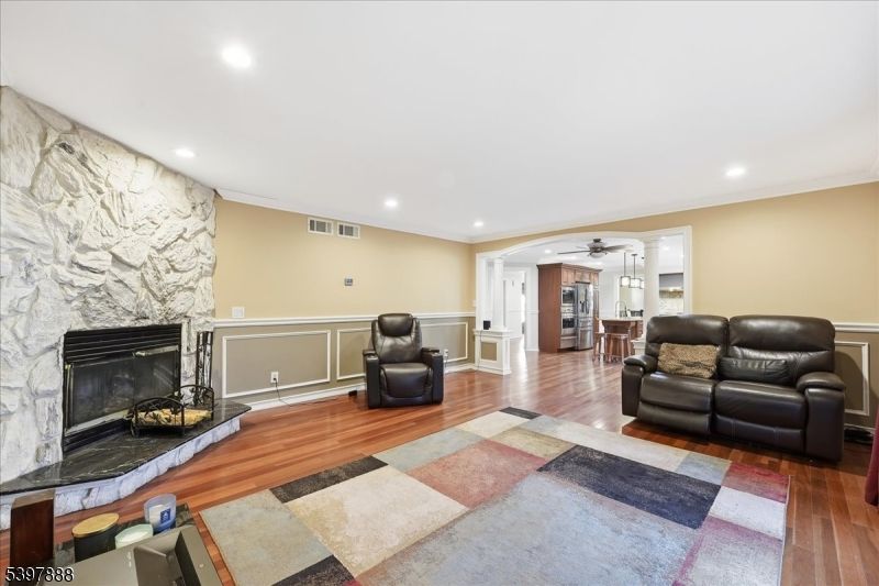 Fireplace, Interior, Living room, Recessed Lighting, Stone Walls, Wood Texture Flooring