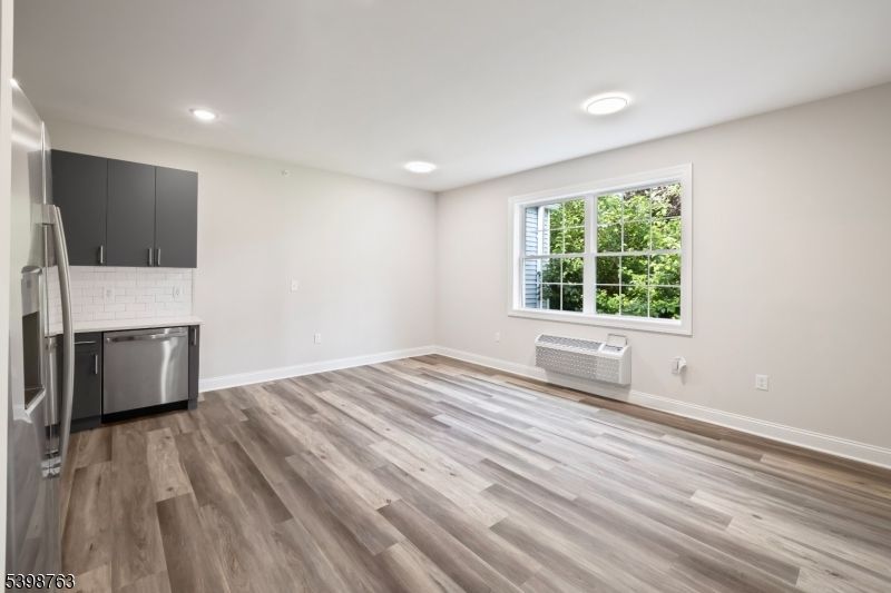 Empty room, Interior, Kitchen, Recessed Lighting, Stainless Steel Appliances, Wood Texture Flooring