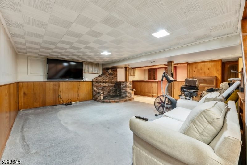 Fireplace, Fitness Equipment, Interior, Living room, Recessed Lighting, Stone Walls, Wooden Walls