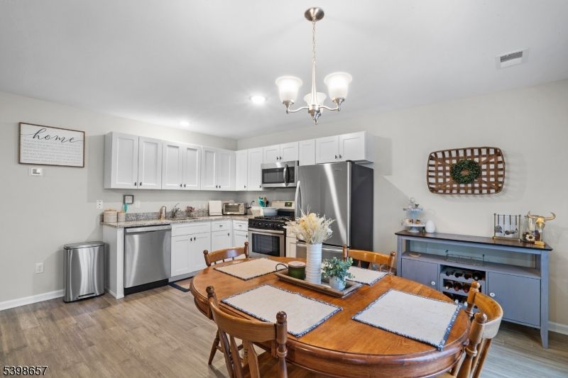 Chandelier, Dining room, Interior, Kitchen, Pendant Lights, Recessed Lighting, Stainless Steel Appliances, Wood Texture Flooring