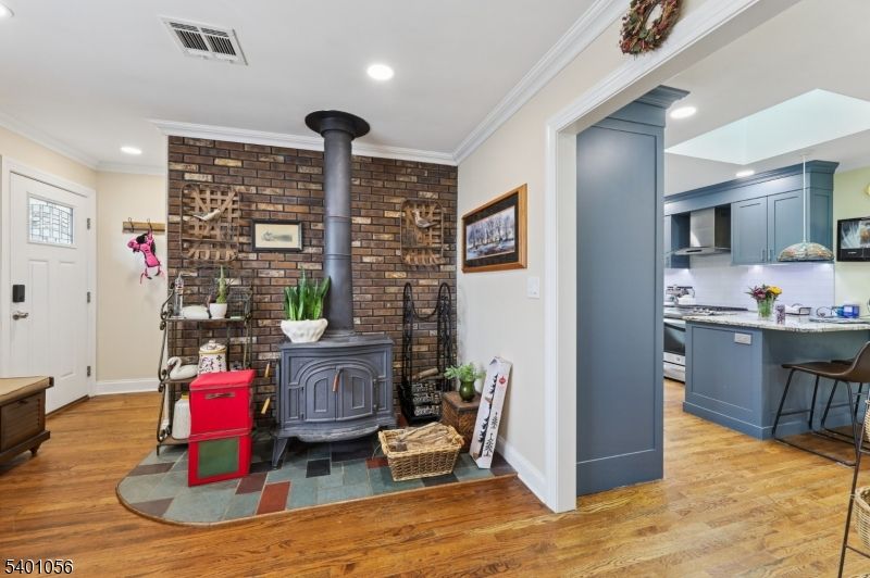 Fireplace, Interior, Kitchen, Recessed Lighting, Stainless Steel Appliances, Stone Walls, Wood Texture Flooring