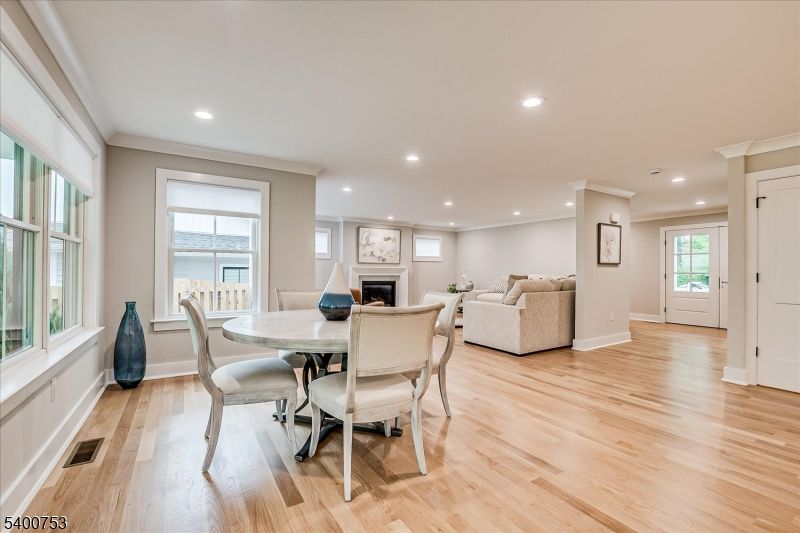 Dining room, Fireplace, Interior, Living room, Recessed Lighting, Wood Texture Flooring