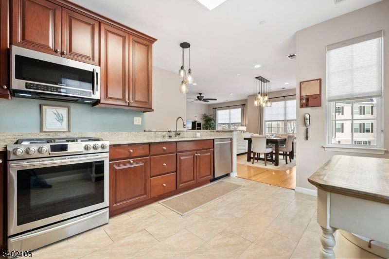 Chandelier, Dining room, Interior, Kitchen, Pendant Lights, Recessed Lighting, Stainless Steel Appliances, Wood Texture Flooring