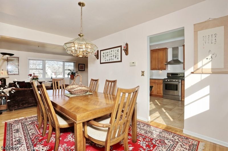 Chandelier, Dining room, Interior, Kitchen, Living room, Pendant Lights, Stainless Steel Appliances, Wood Texture Flooring