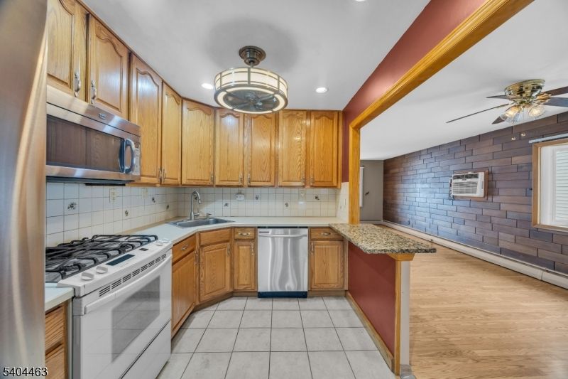 Interior, Kitchen, Pendant Lights, Recessed Lighting, Stainless Steel Appliances, Stone Walls, Wood Texture Flooring
