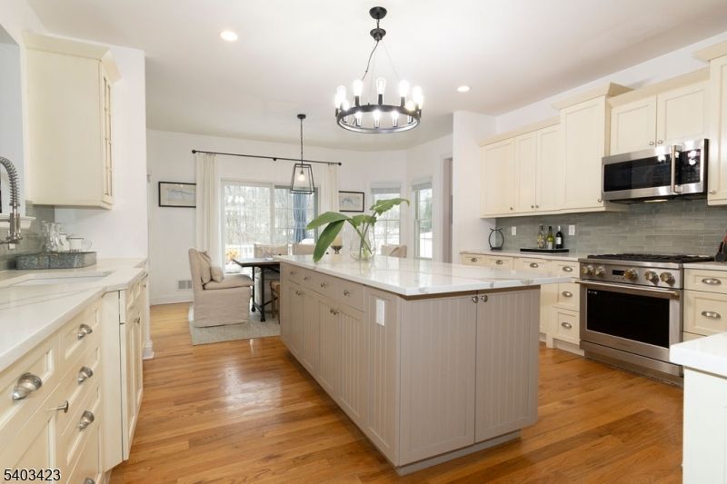 Chandelier, Dining room, Interior, Kitchen, Pendant Lights, Recessed Lighting, Stainless Steel Appliances, Wood Texture Flooring