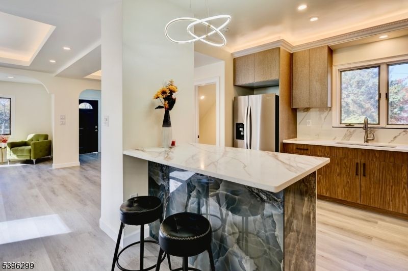 Interior, Kitchen, Marble Walls, Pendant Lights, Recessed Lighting, Stainless Steel Appliances, Wood Texture Flooring