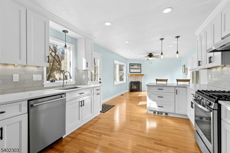 Fireplace, Interior, Kitchen, Pendant Lights, Recessed Lighting, Stainless Steel Appliances, Wood Texture Flooring