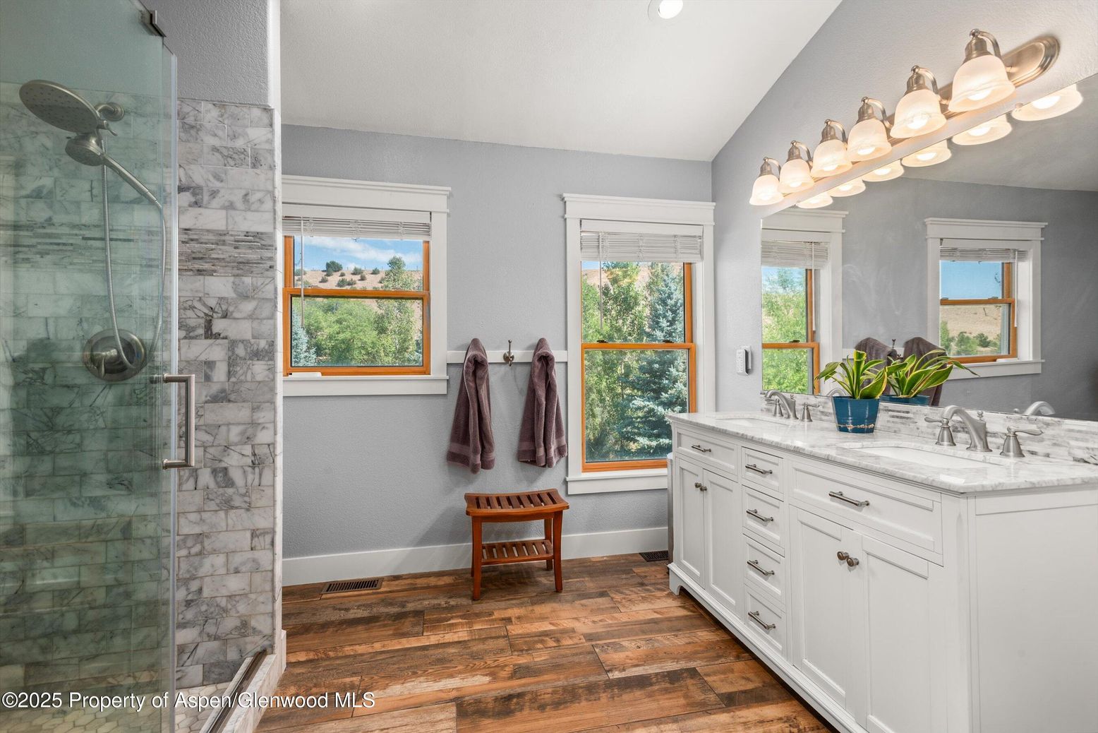 Bathroom, Dual Sink Vanities, Glass Shower, Interior, Marble Walls, Recessed Lighting, Wood Texture Flooring