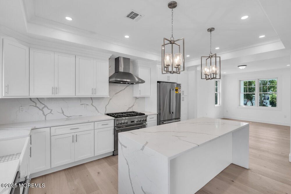 Interior, Kitchen, Marble Walls, Pendant Lights, Recessed Lighting, Stainless Steel Appliances, Wood Texture Flooring