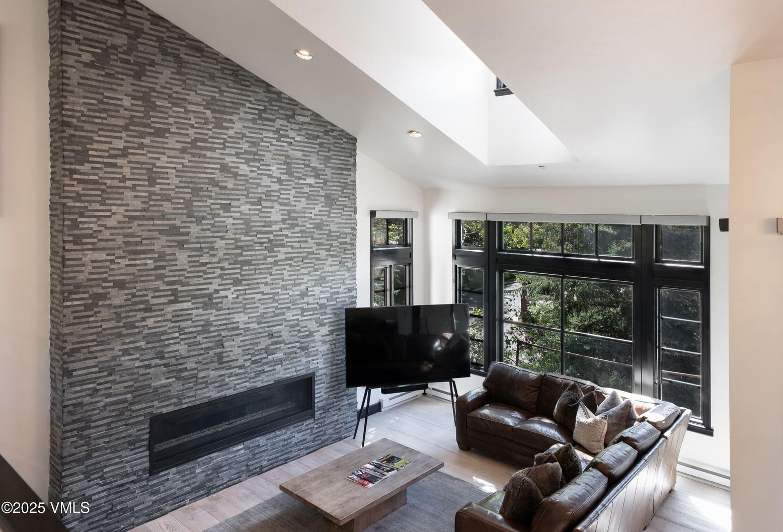 Fireplace, Interior, Living room, Recessed Lighting, Stone Walls, Wood Texture Flooring