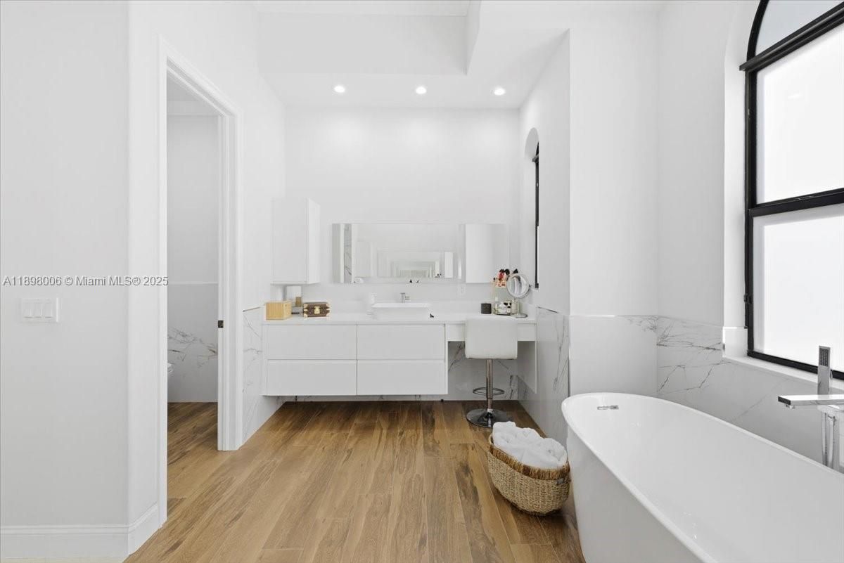 Bathroom, Free Standing Baths, Interior, Marble Walls, Recessed Lighting, Wood Texture Flooring