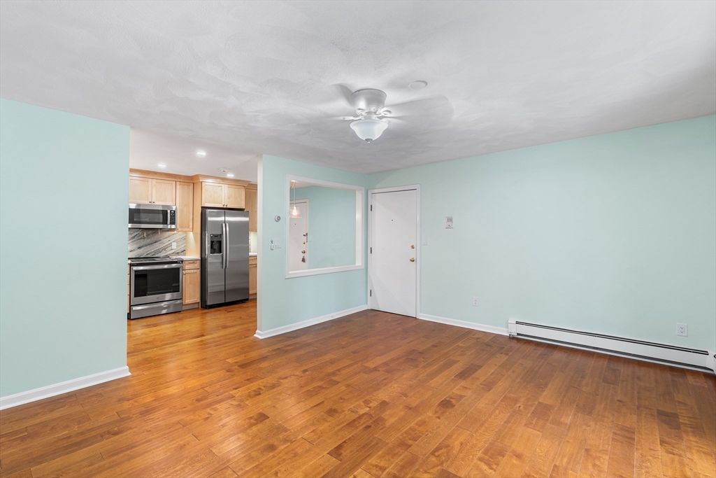 Empty room, Interior, Kitchen, Recessed Lighting, Stainless Steel Appliances, Wood Texture Flooring