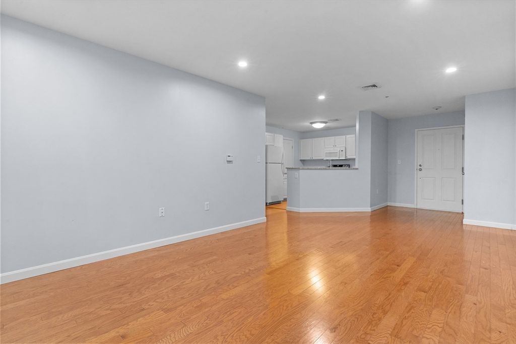 Empty room, Interior, Kitchen, Recessed Lighting, Stainless Steel Appliances, Wood Texture Flooring