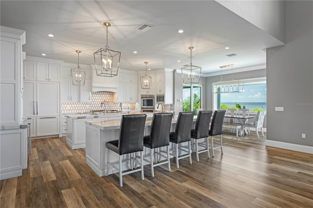 Chandelier, Dining room, Interior, Kitchen, Pendant Lights, Recessed Lighting, Stainless Steel Appliances, Water, Wood Texture Flooring