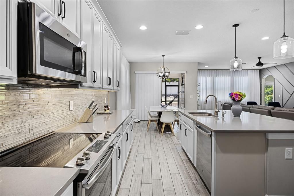 Dining room, Interior, Kitchen, Pendant Lights, Recessed Lighting, Stainless Steel Appliances, Wood Texture Flooring