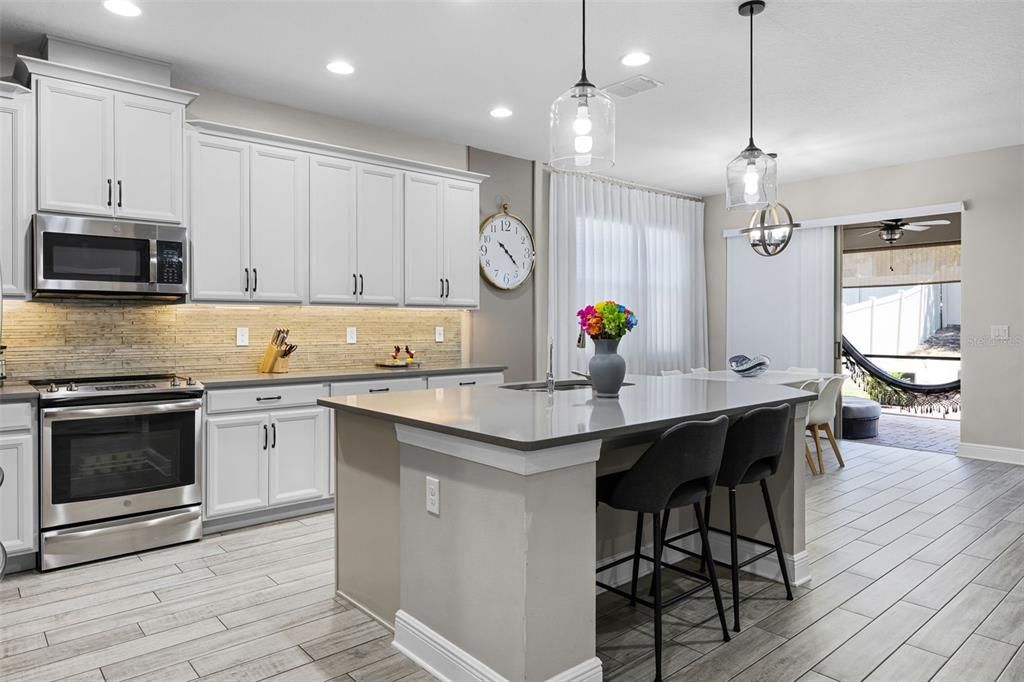 Dining room, Interior, Kitchen, Pendant Lights, Recessed Lighting, Stainless Steel Appliances, Wood Texture Flooring
