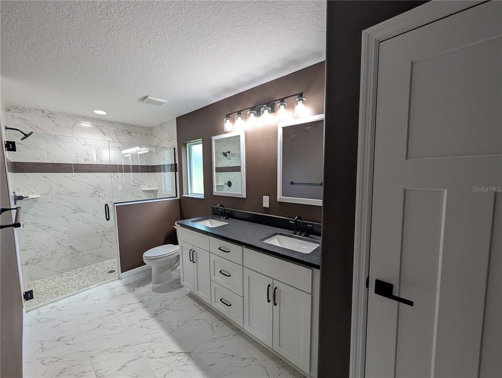 Bathroom, Dual Sink Vanities, Glass Shower, Interior, Marble, Marble Walls, Recessed Lighting