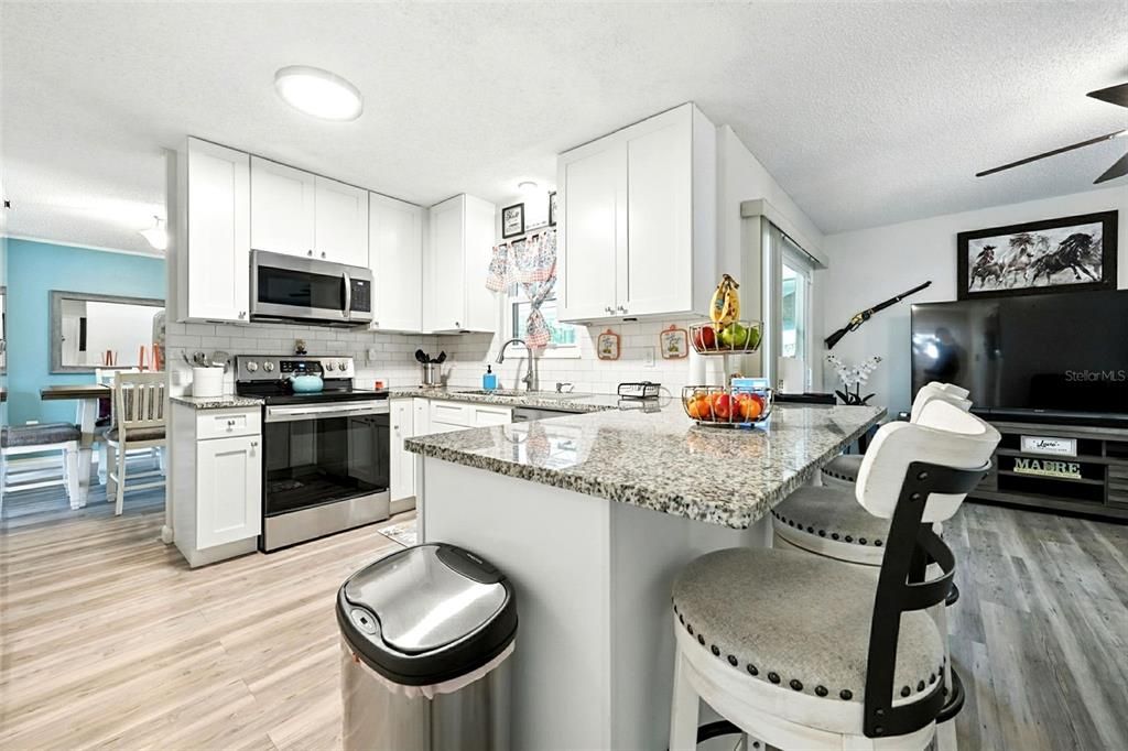 Dining room, Interior, Kitchen, Recessed Lighting, Stainless Steel Appliances, Wood Texture Flooring