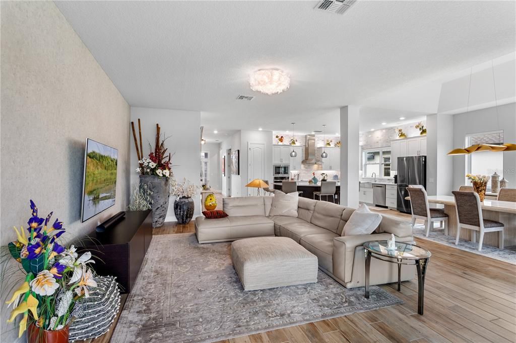 Chandelier, Dining room, Interior, Kitchen, Living room, Pendant Lights, Recessed Lighting, Stainless Steel Appliances, Wood Texture Flooring