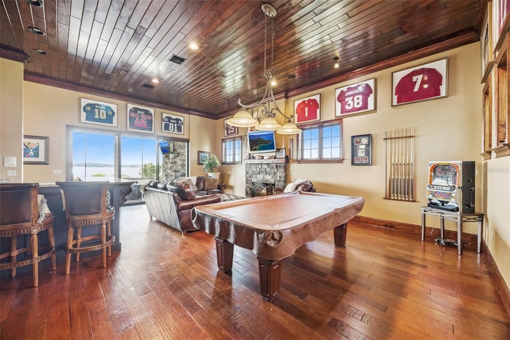 Billiard Table, Fireplace, Game Room, Interior, Living room, Pendant Lights, Recessed Lighting, Wooden Ceilings, Wood Texture Flooring