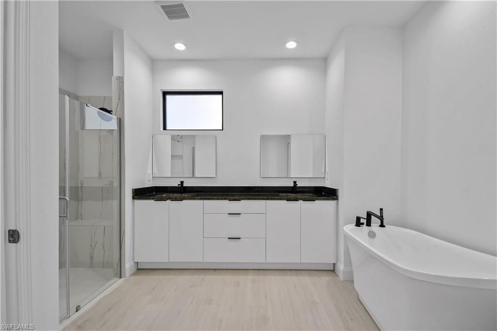 Bathroom, Dual Sink Vanities, Free Standing Baths, Glass Shower, Interior, Recessed Lighting, Wood Texture Flooring