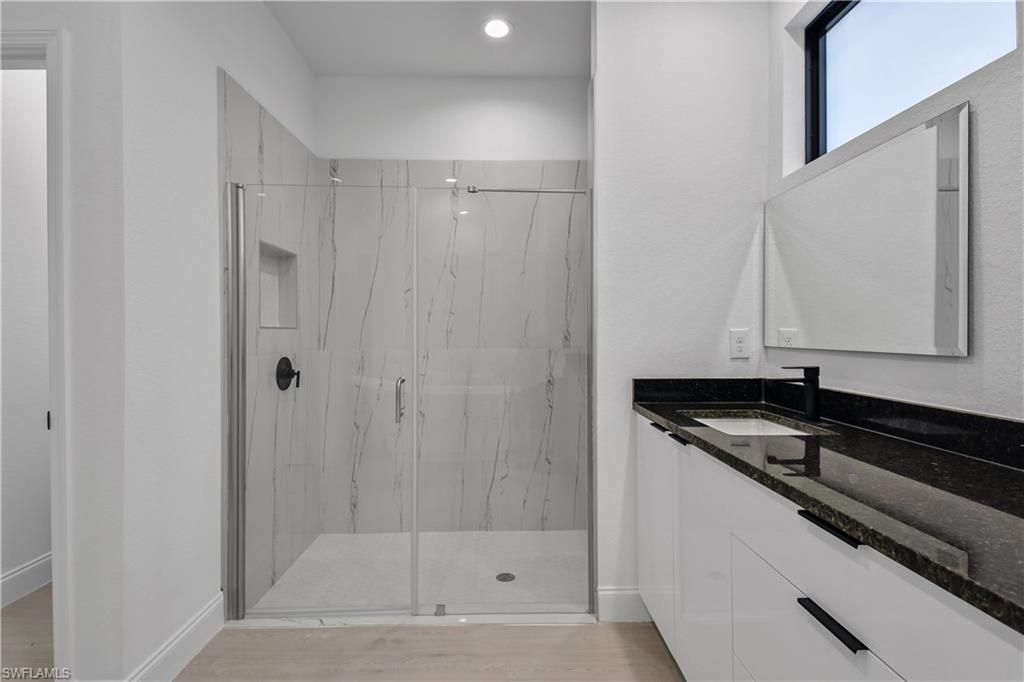 Bathroom, Glass Shower, Interior, Marble Walls, Recessed Lighting, Wood Texture Flooring