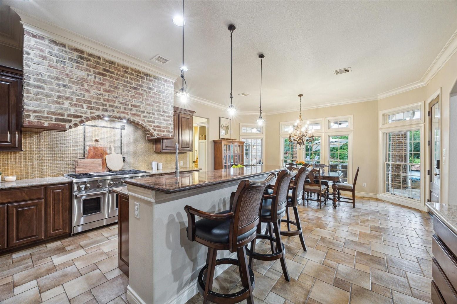 Chandelier, Dining room, Interior, Kitchen, Pendant Lights, Recessed Lighting, Stainless Steel Appliances, Stone Walls