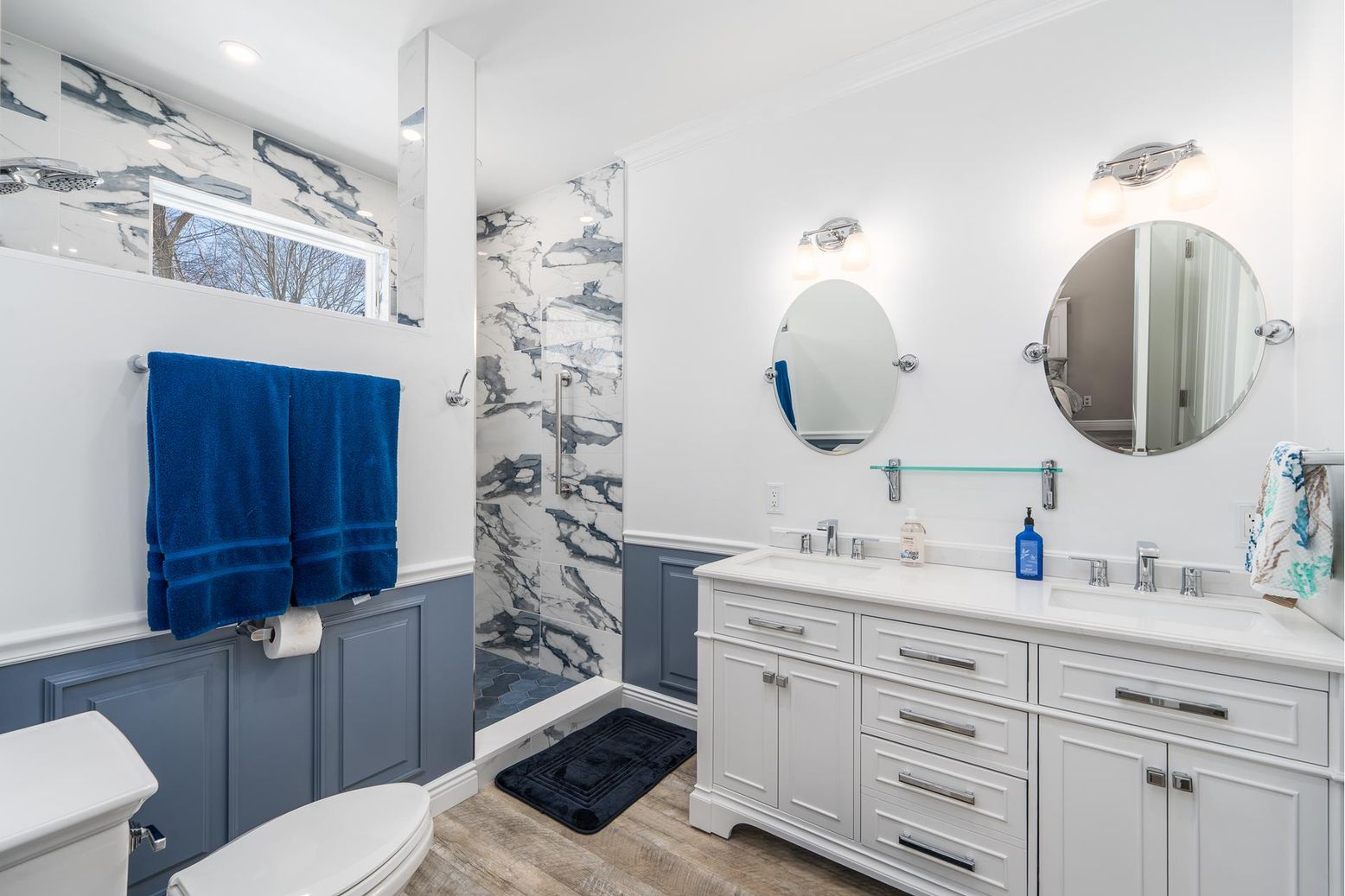 Bathroom, Dual Sink Vanities, Interior, Marble Walls, Recessed Lighting, Wood Texture Flooring