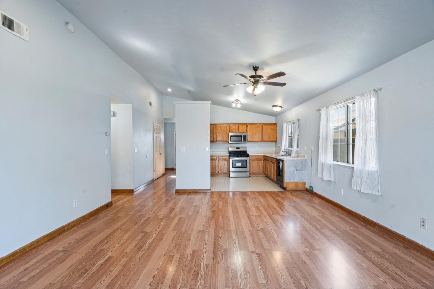 Empty room, Interior, Kitchen, Recessed Lighting, Stainless Steel Appliances, Wood Texture Flooring