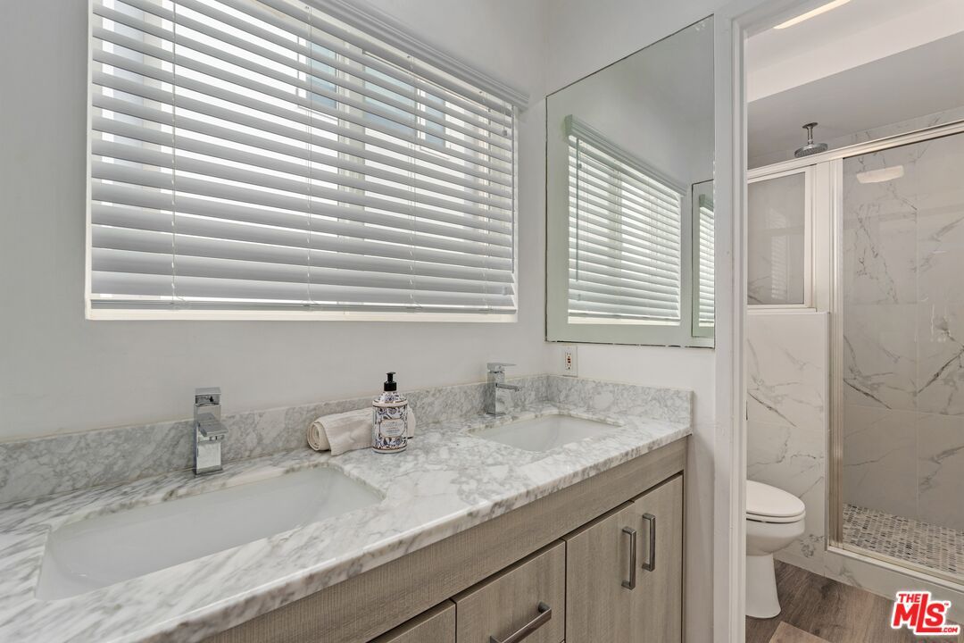 Bathroom, Dual Sink Vanities, Glass Shower, Interior, Marble Walls, Wood Texture Flooring