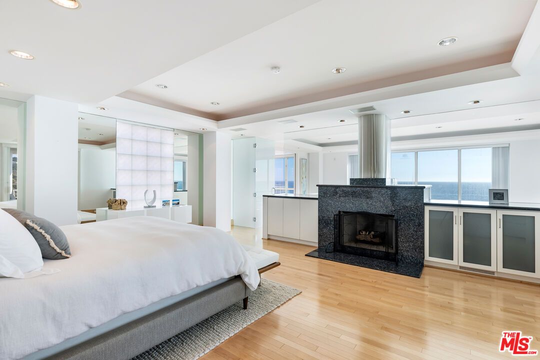 Bedroom, Fireplace, Interior, Recessed Lighting, Water, Wood Texture Flooring