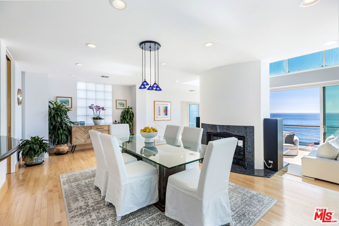 Dining room, Fireplace, Interior, Living room, Pendant Lights, Recessed Lighting, Water, Wood Texture Flooring