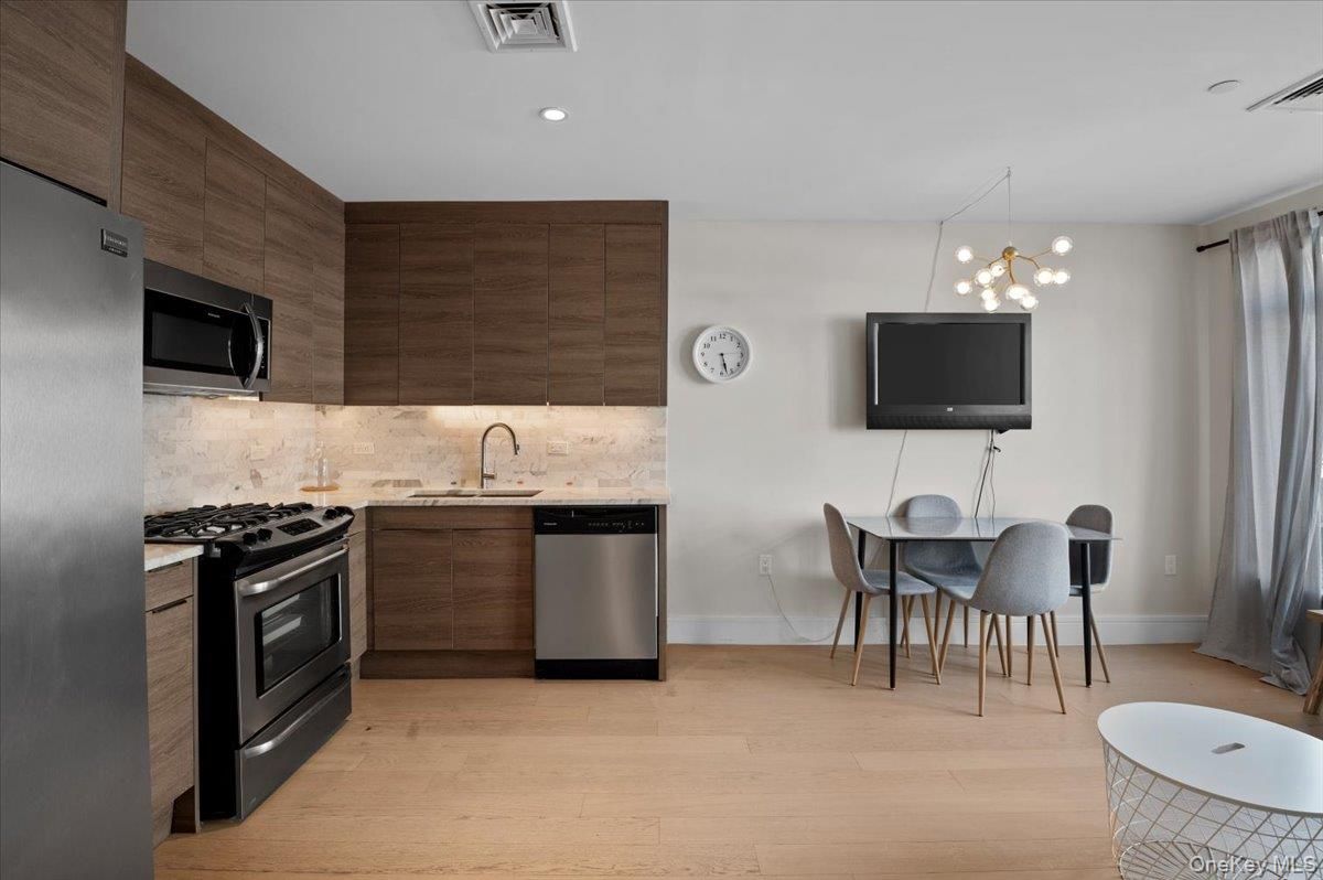 Dining room, Interior, Kitchen, Pendant Lights, Recessed Lighting, Stainless Steel Appliances, Wood Texture Flooring